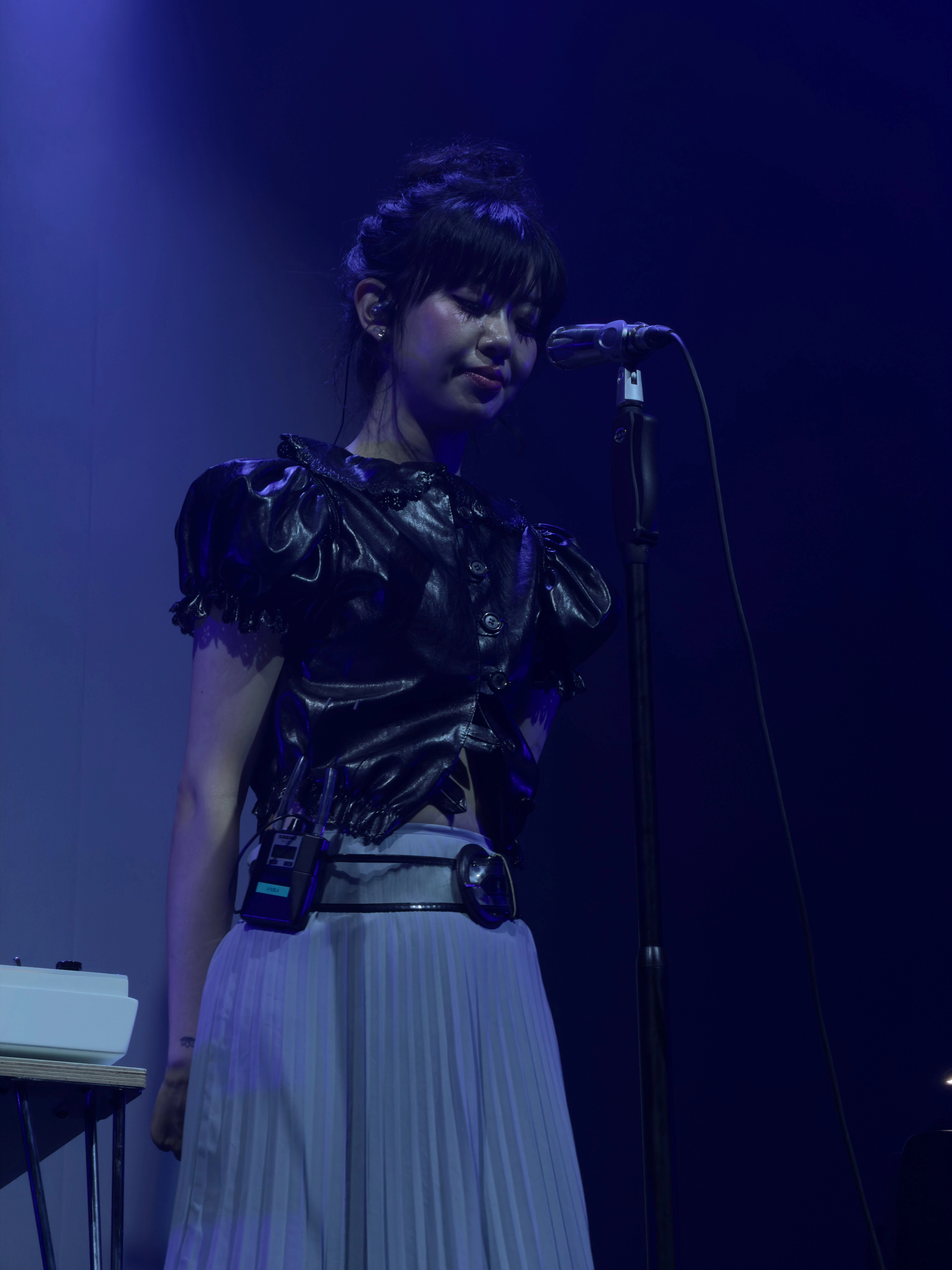 마이크 스탠드 앞에 서 있는 윤지영의 모습.