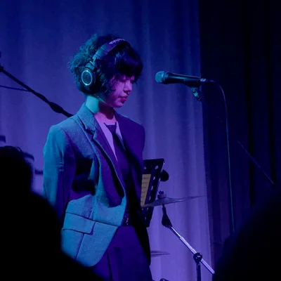 헤드폰을 쓰고 있는 윤지영이 아래를 내려다 보고 있다.